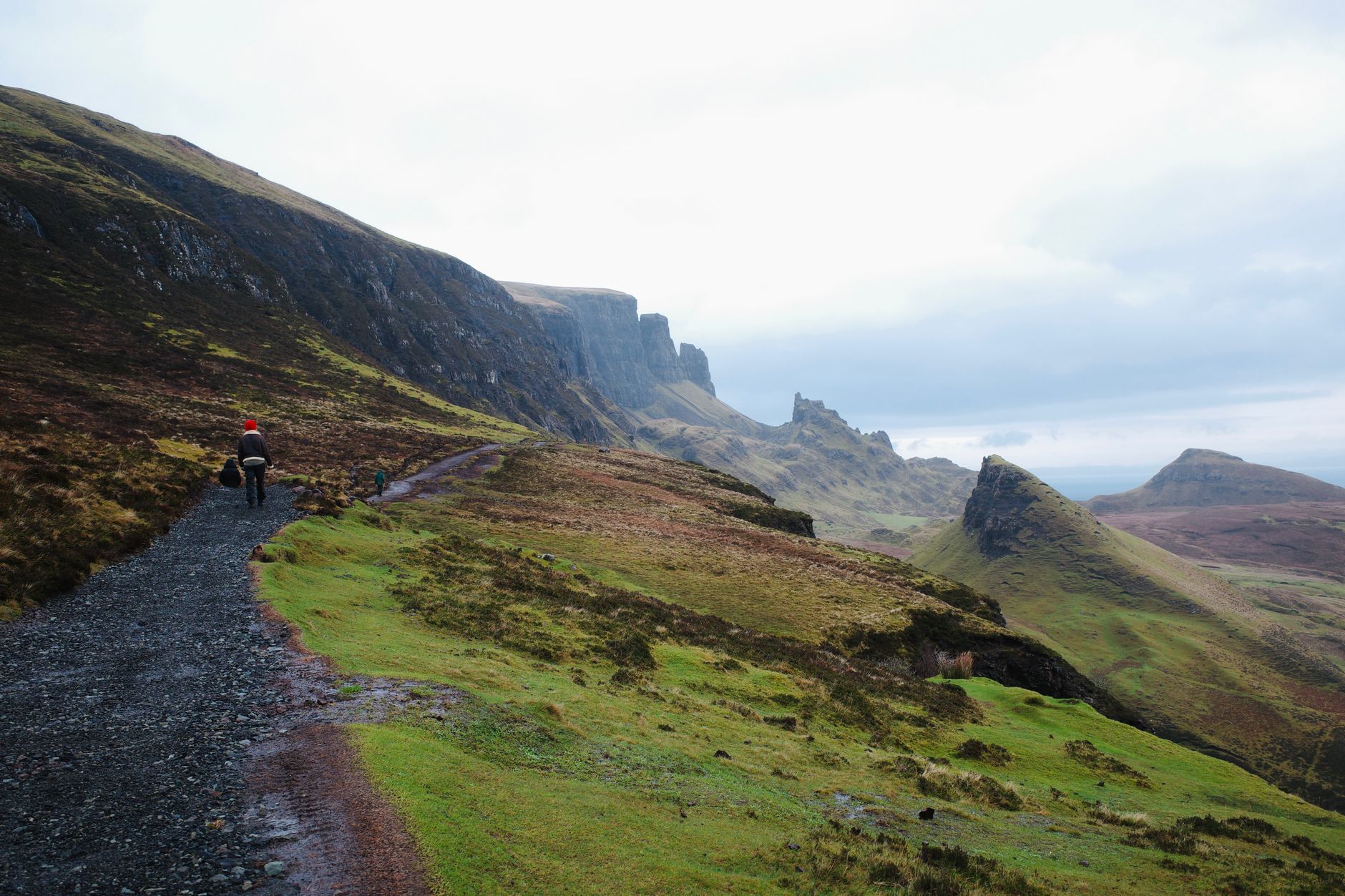 Hiker studying a map on a Scottish mountain path when hiking Glencoe by public transport