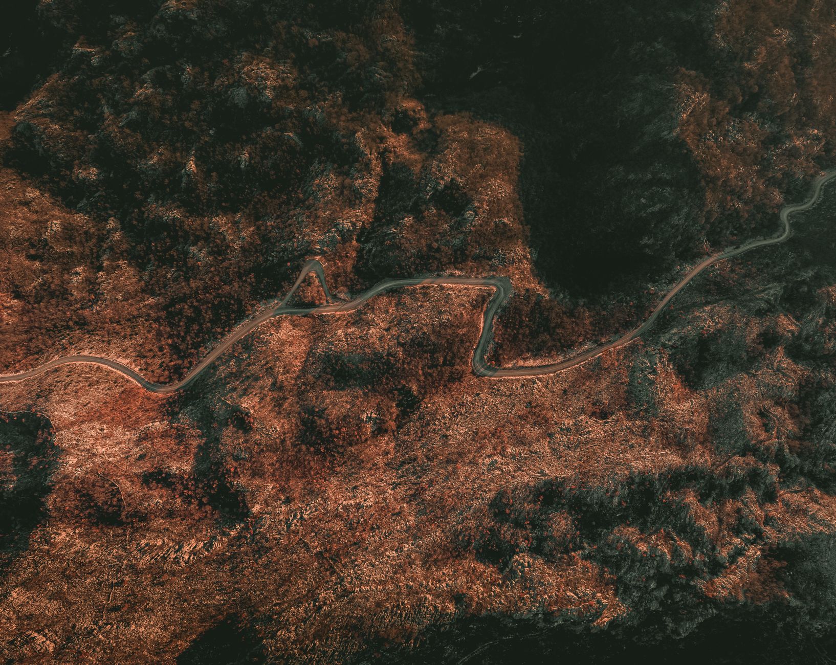 Close-up of compass on contour map showing steep mountain terrain for navigation